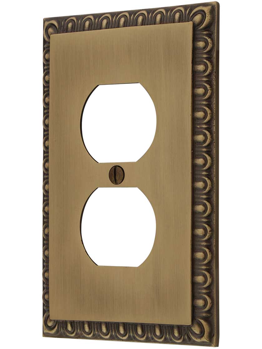 Ovolo Single Duplex Outlet Cover Plate in Antique Brass.